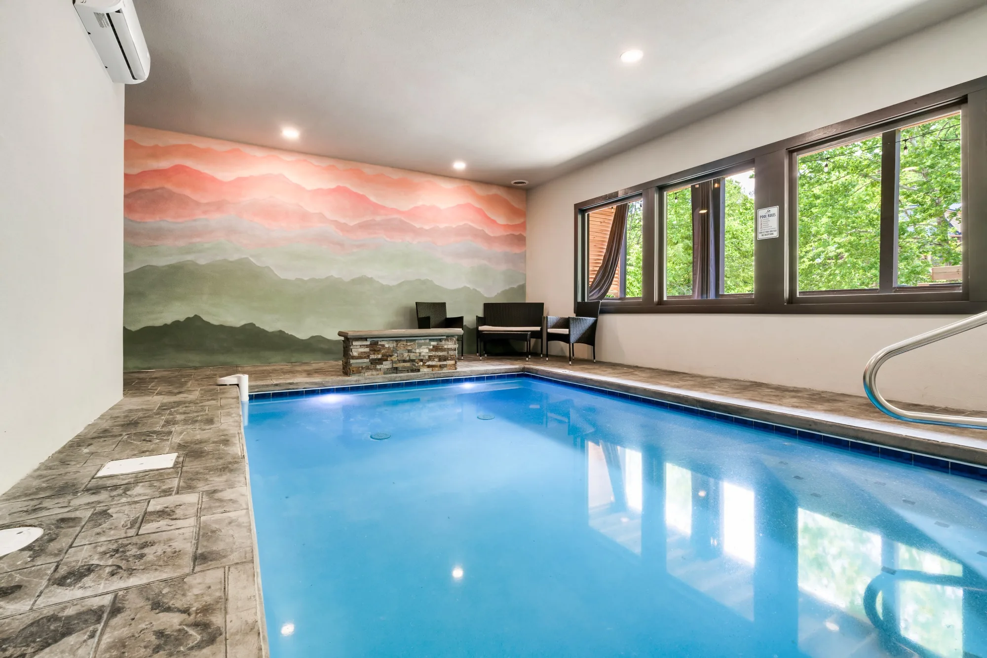 Indoor pool with mountain mural